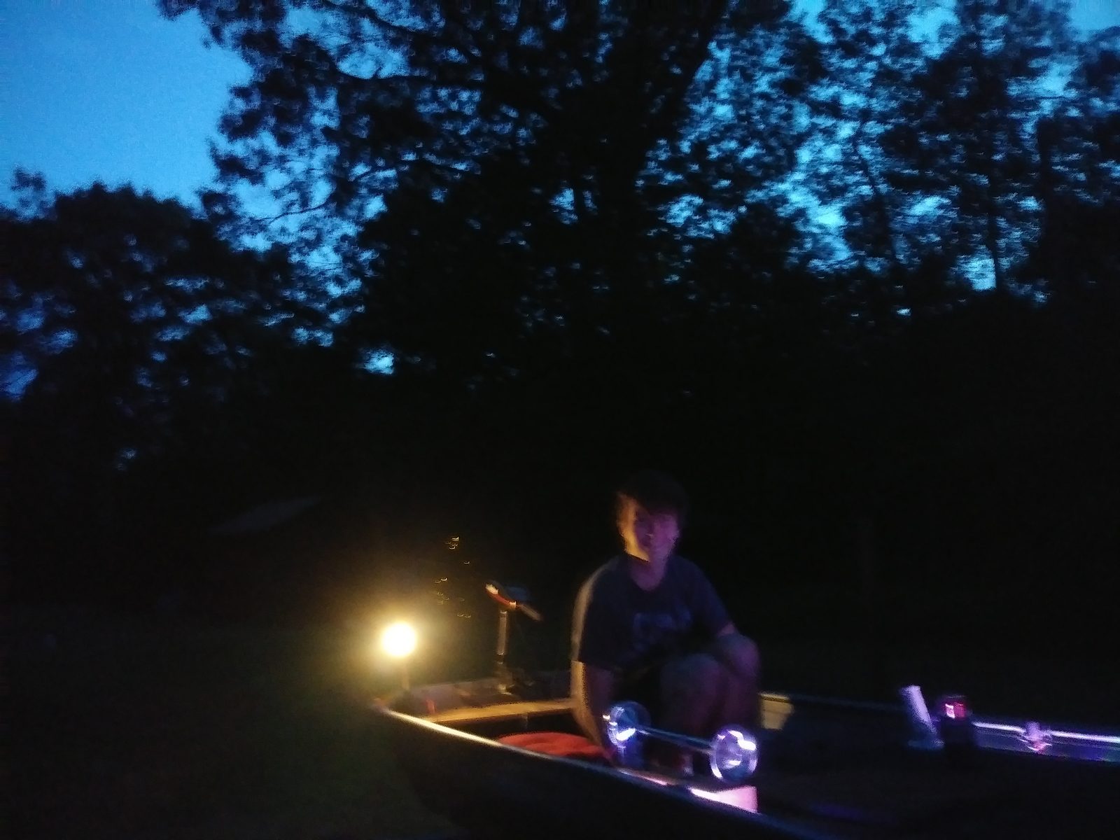 Dusk test of the boat's new lighting, lantern glowing beside the trailer